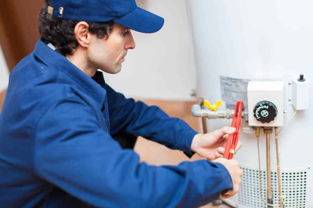 Technician performing heating repair for a Claremont, CA home Technician performing heating repair for a Claremont, CA home